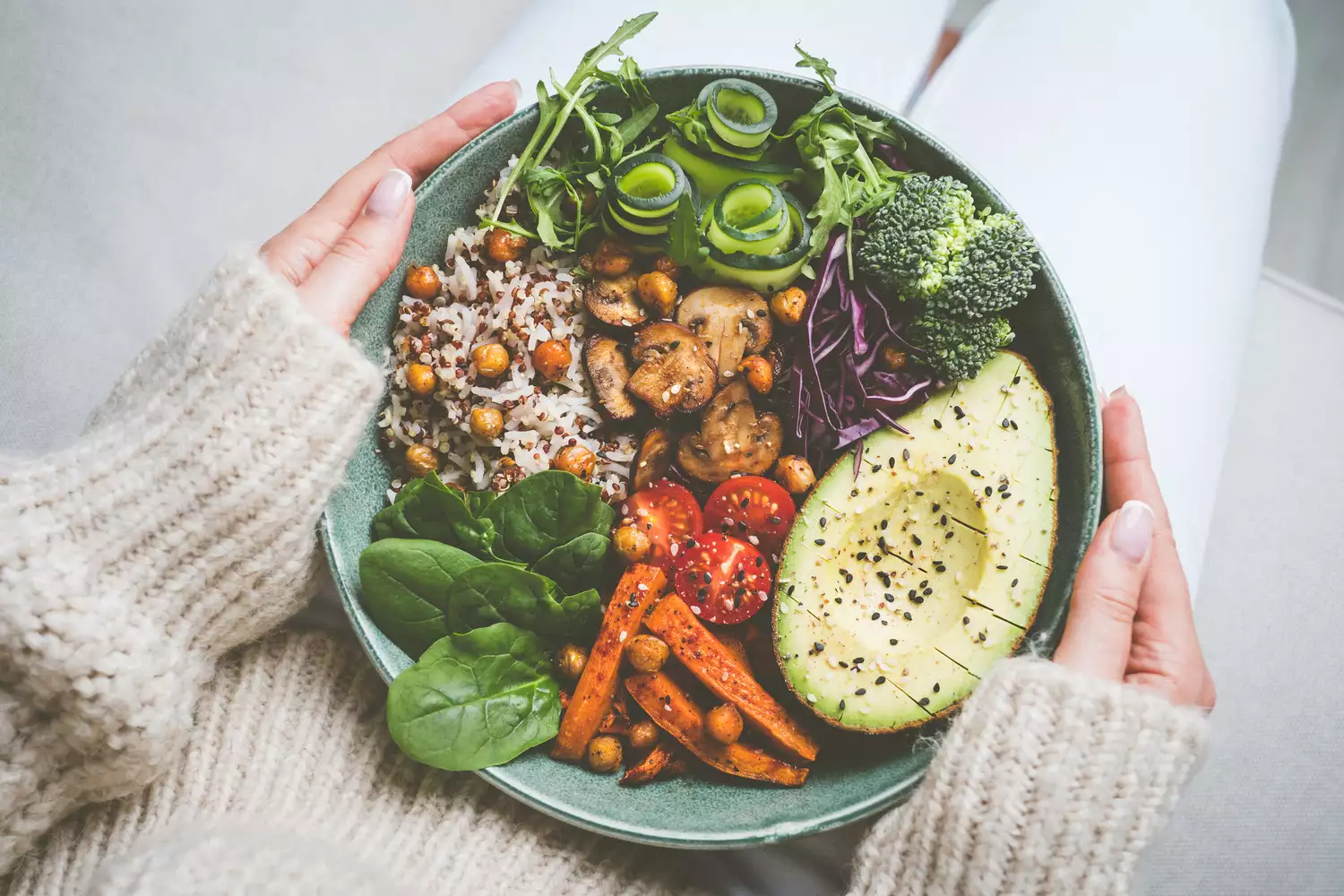 Healthy eating and healthy diet. Woman holding plate with fresh vegan or vegetarian food. Healthy vegan meal. Vegan buddha bowl with healthy food