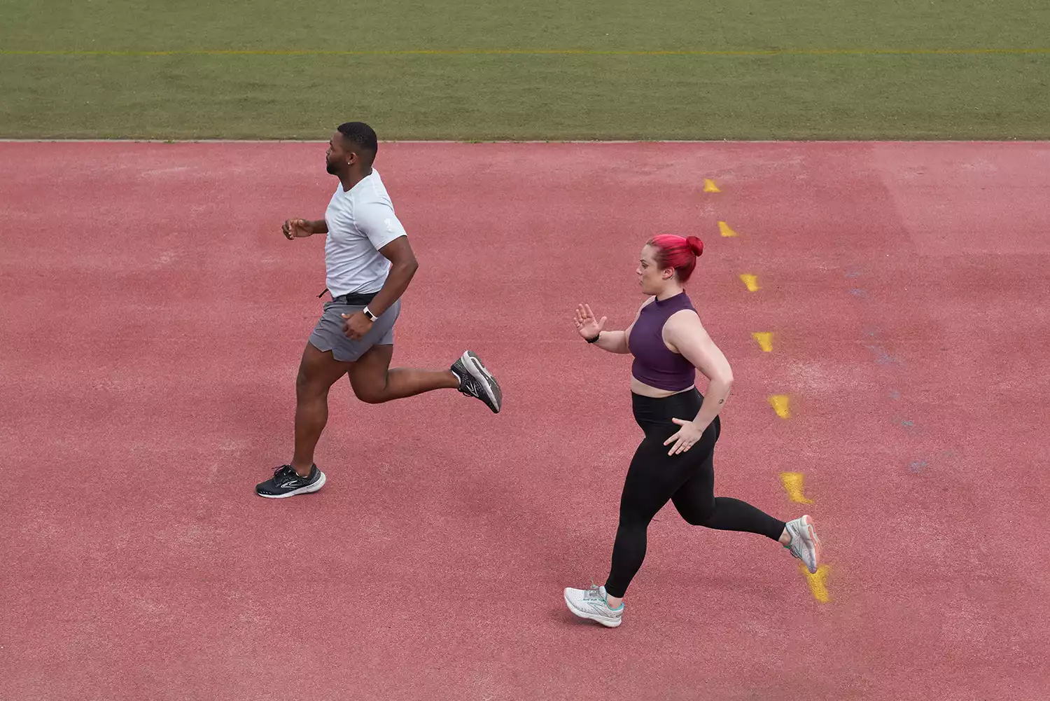 man and woman running on a track