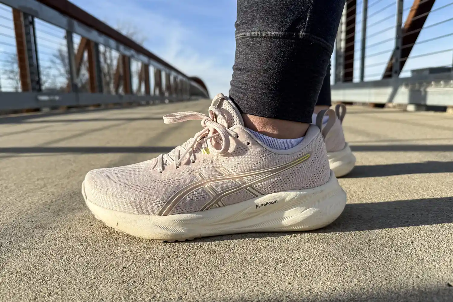 The Asics Women's GEL-Pulse 16 worn on a bridge viewed at a side angle
